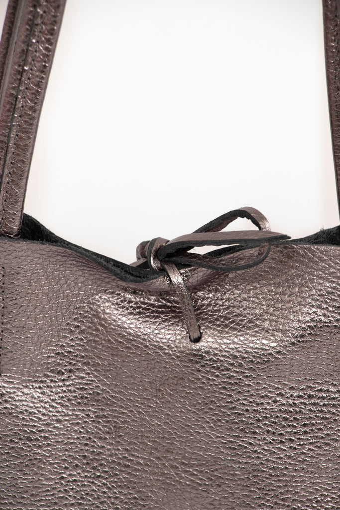close up of the top tie fastening on the pewter leather tote bag