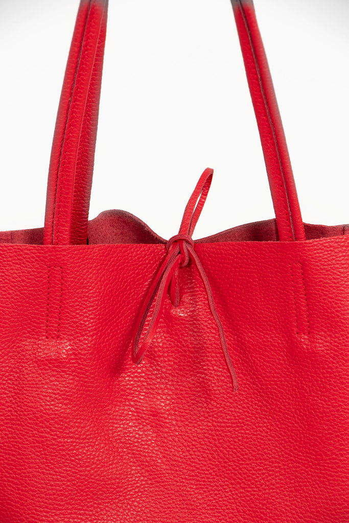 close up of the top tie fastening on the red leather tote bag