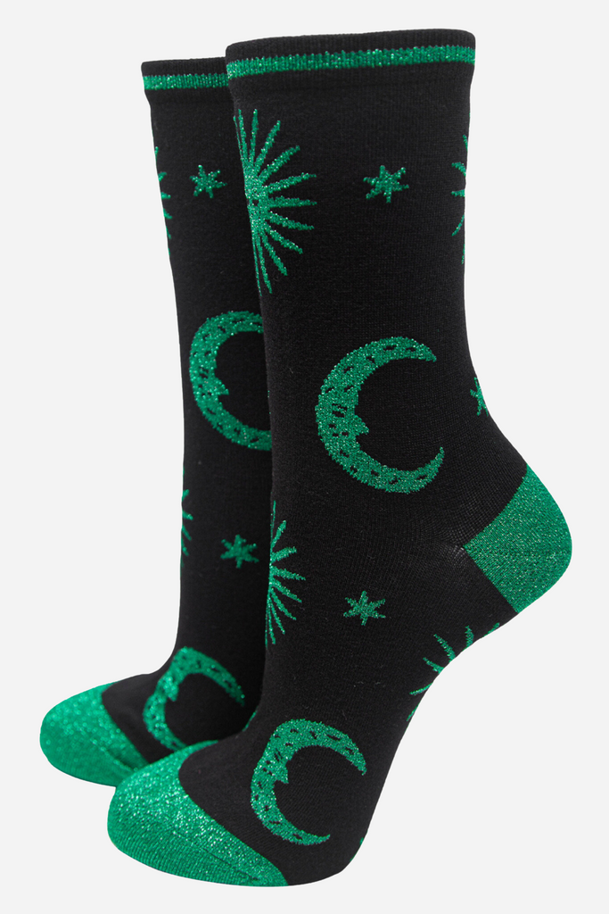 black socks with green, stars, crescent moons and suns with green sparkly glitter accents 