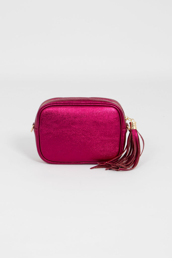 diagonal view of pink metallic camera bag showing the zip closure