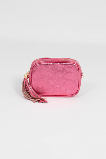 metallic hot pink leather crossbody camera bag with a tassel and matching detachable bag strap