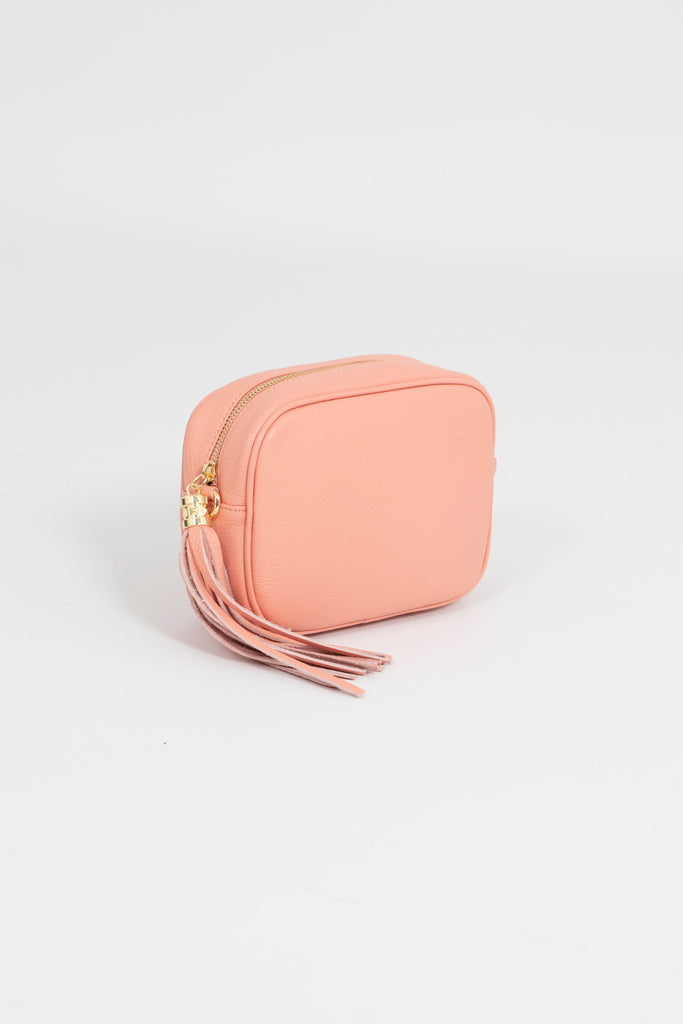 salmon pink leather crossbody camera bag with matching detachable bag strap