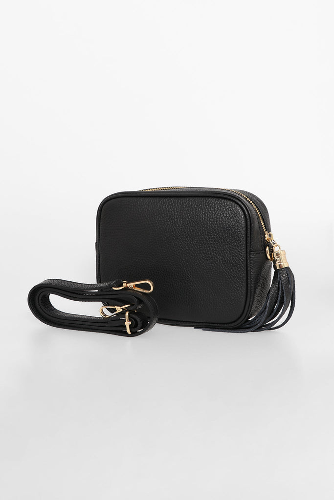 black pebbled leather crossbody camera bag with a detachable bag strap and gold hardware