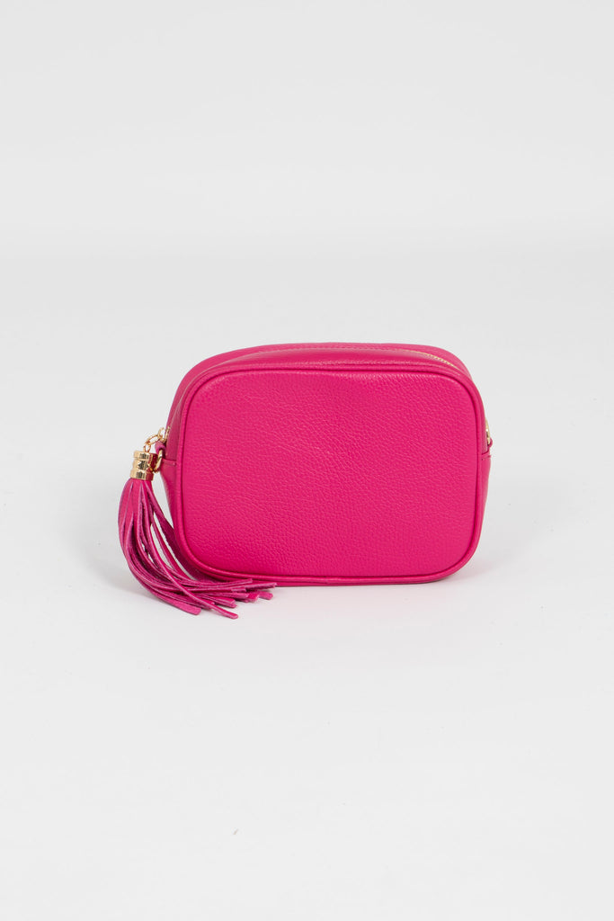 vibrant pink leather crossbody camera bag with matching detachable bag strap