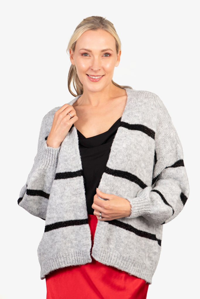 model wearing a light grey knitted open front cardigan with black glitter horizontal stripes