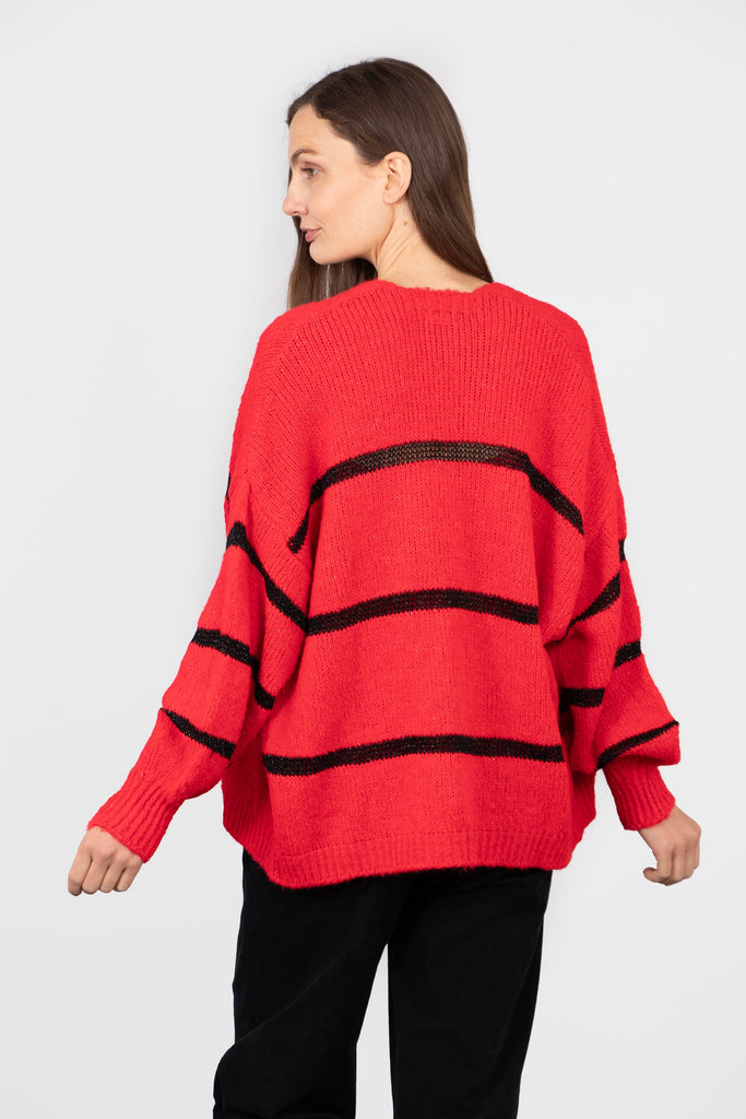 model showing the back of the cardigan, the horizontal black stripe runs throughout the design