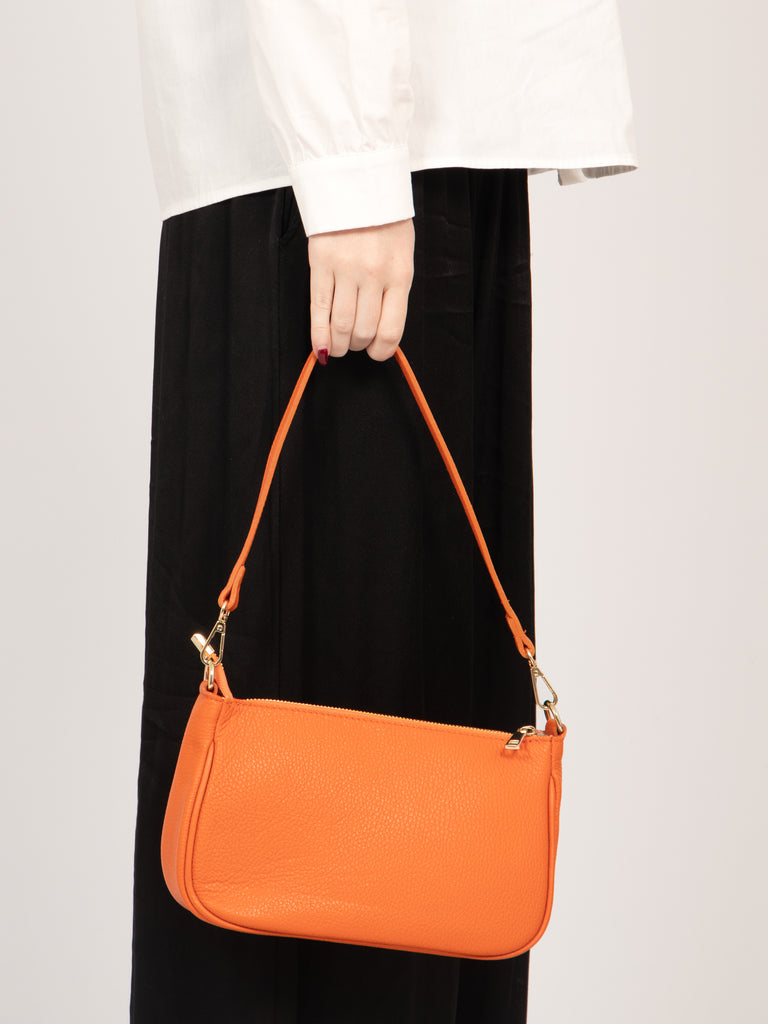chloe-italian-leather-baguette-bag-orange-pebbled-held-by-strap-by-model