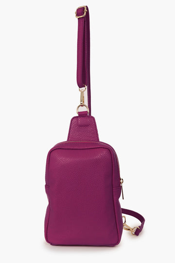 cranberry coloured leather sling bag with a detachable matching crossbody strap