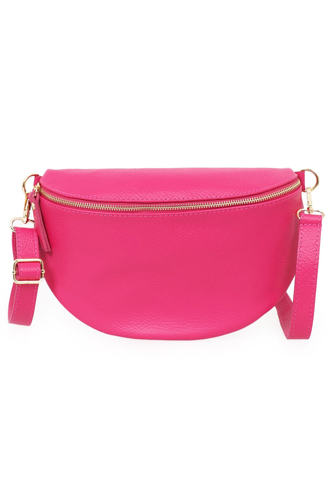 close up of the pink pebbled leather bag, showing clearly the zip closure and adjustable strap