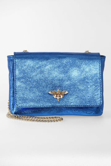 metallic blue leather crossbody bag with a gold chain strap and a gold bee clasp on the front