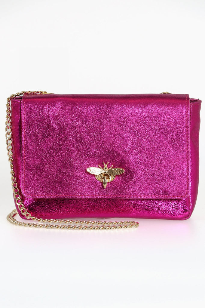 pink metallic glitter leather crossbody bag with a gold chain strap and a gold bee clasp on the front