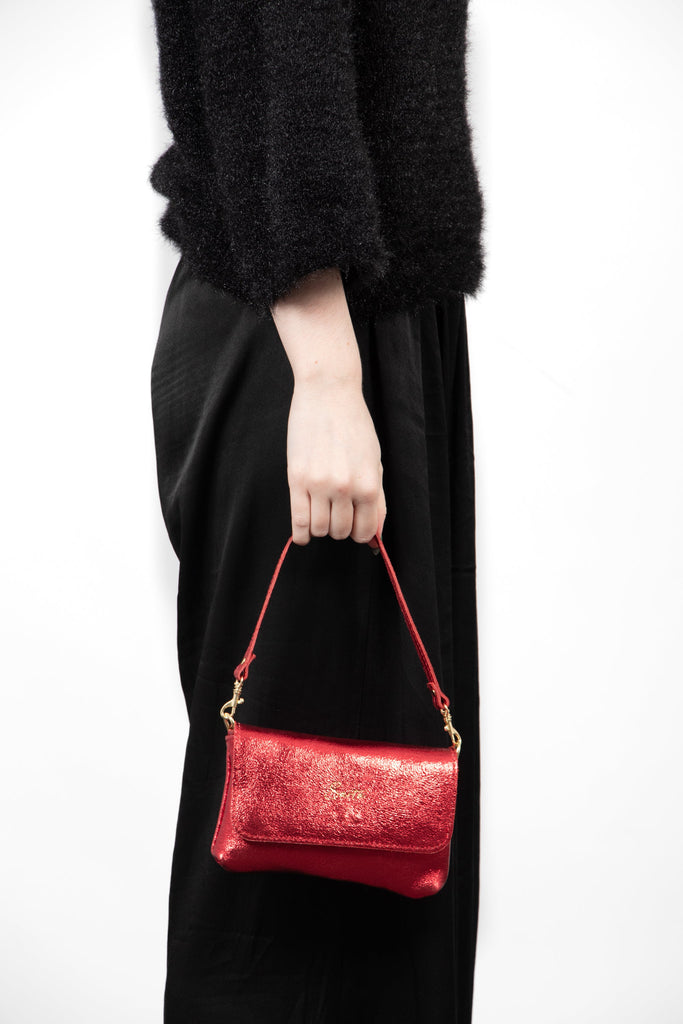 olga-metallic-italian-leather-mini-crossbody-bag-scarlet-held-by-model