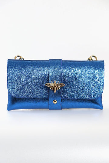 metallic blue leather clutch bag with a detachable gold chain strap and a gold bee clasp on the front