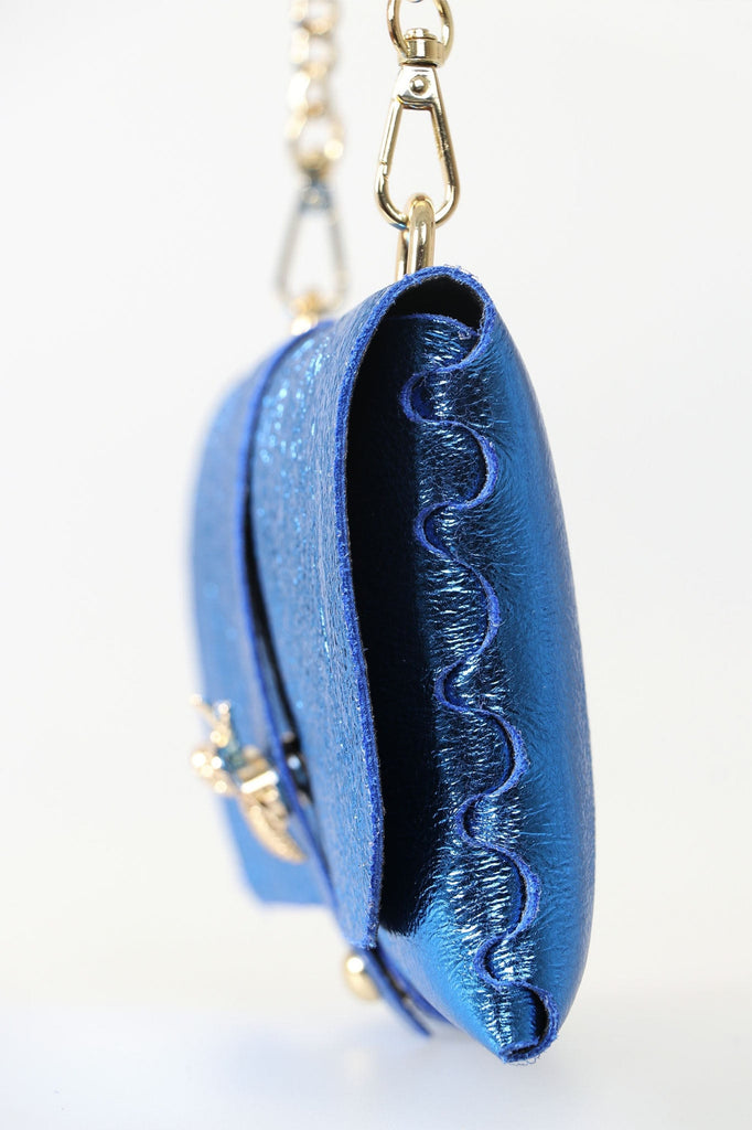 close up of the metallic blue leather and the gold bee clasp