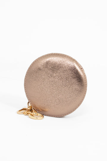 rose gold champagne coloured round leather coin purse with a zip closure