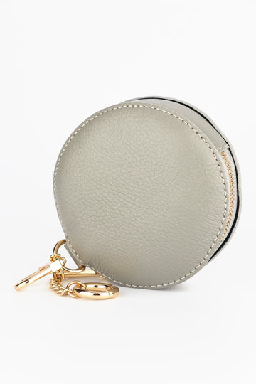 light grey round italian leather coin purse with a zip closure and two clip on keychains