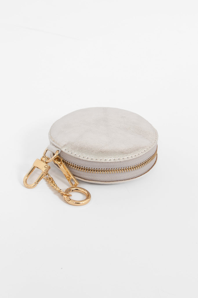 round silver coin purse, showing the zip closure