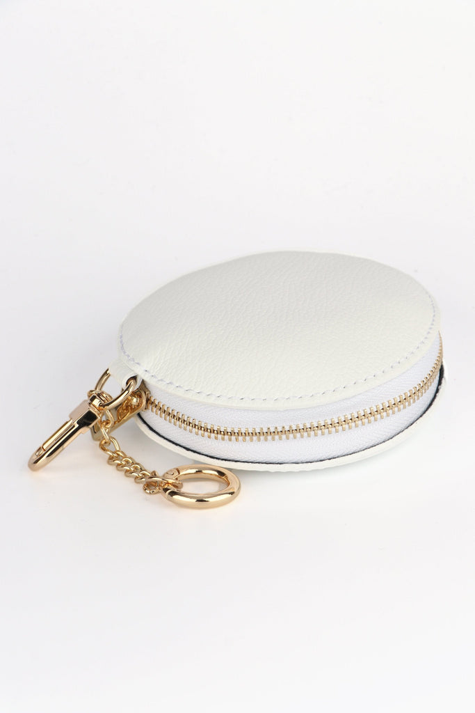 white leather round coin purse with a gold zip closure 