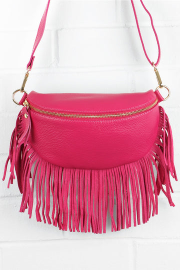 fuchsia pink leather halfmoon bag with fringed trim and zip closure