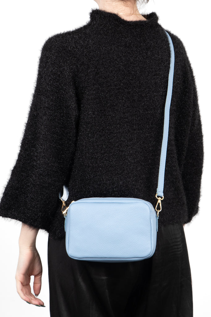 italian-leather-double-section-crossbody-camera-bag-in-azure-worn-by-model