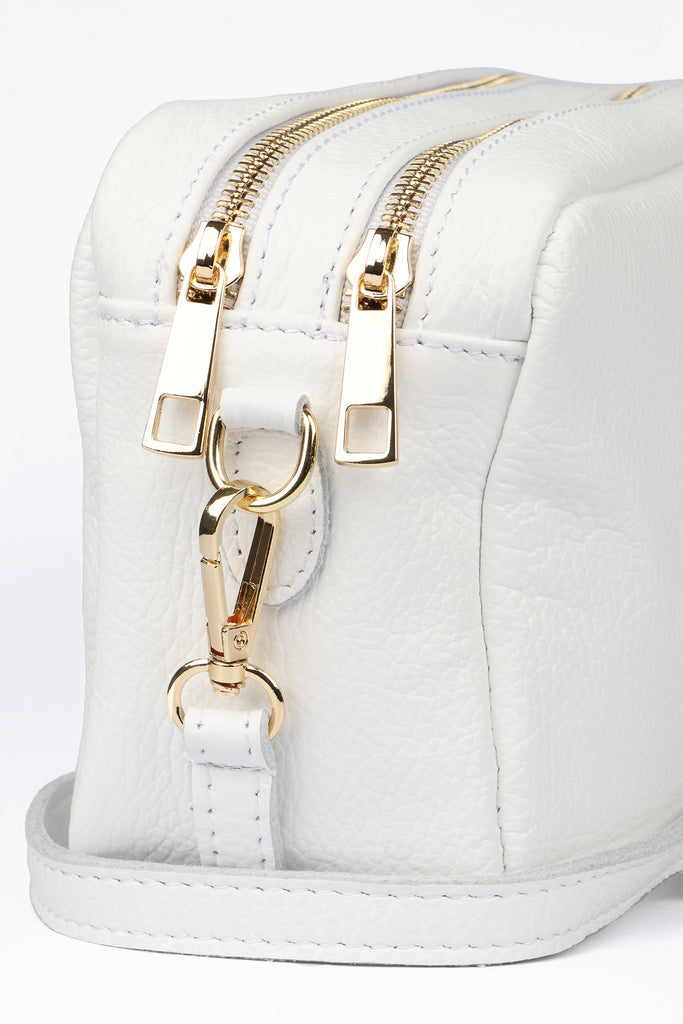 close up of the white genuine italian leather and gold hardware 