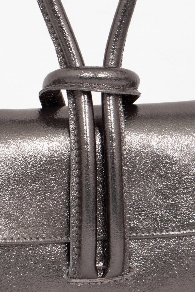 trixie-italian-leather-wristlet-clutch-bag-gun-metal-metallic-close-up-knot-wrist-closure