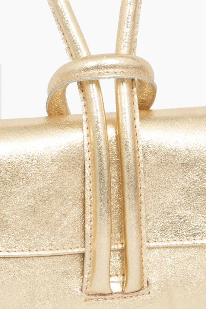 trixie-italian-leather-wristlet-clutch-bag-gold-metallic-close-up-knot-wrist-closure