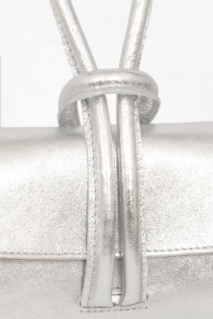 trixie-italian-leather-wristlet-clutch-bag-silver-metallic-close-up-knot-wrist-closure