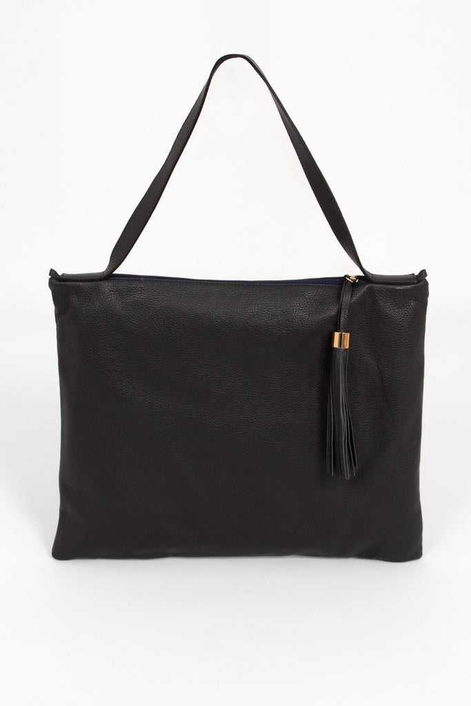 large navy blue leather tote bag with a shoulder strap on the top of the bag and a decorative tassel on the front