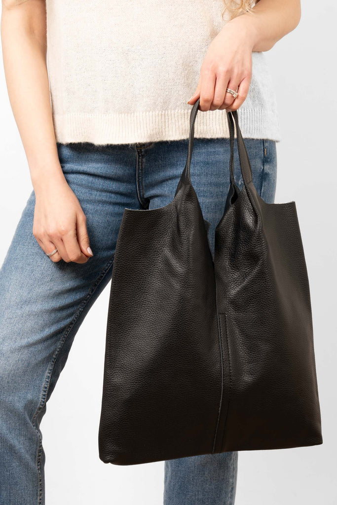 paloma-italian-leather-shoulder-bag-black-pebbled-front-view-held-by-handles