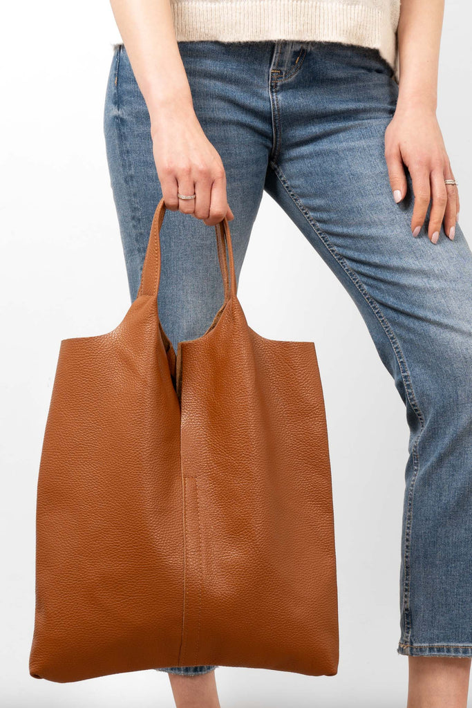 paloma-italian-leather-shoulder-bag-tan-pebbled-model-holding-close-up