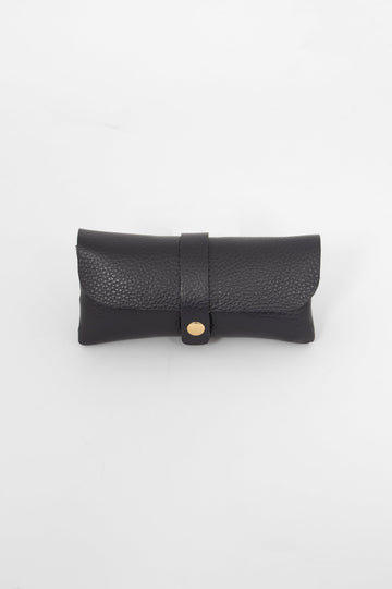 pebbled navy blue leather sunglasses case. the case wraps around the glasses and closes with a front gold button fastening