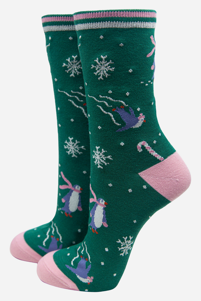 green bamboo socks with skating penguins and silver glitter accents