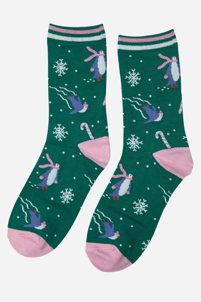 green glitter xmas socks featuring skating penguins