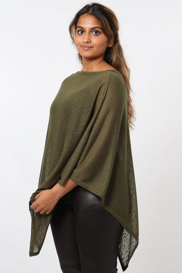 model wearing a plain khaki lightweight poncho with an asymmetrical hemline and short wide sleeves