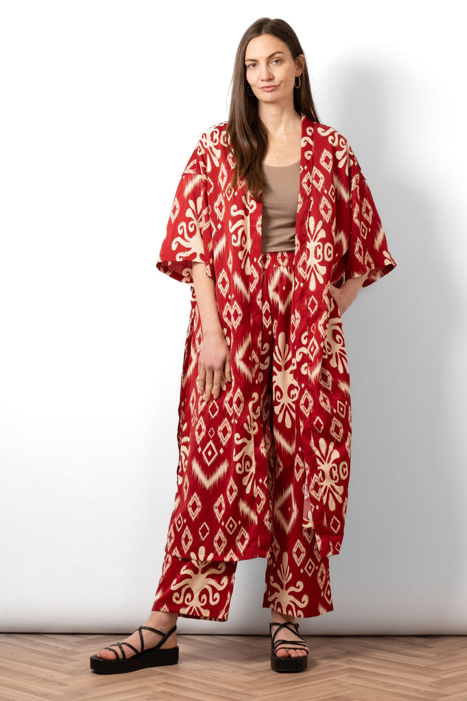 serena-lightweight-long-kimono-red-ikat-worn-on-model-paired-with-matching-trousers