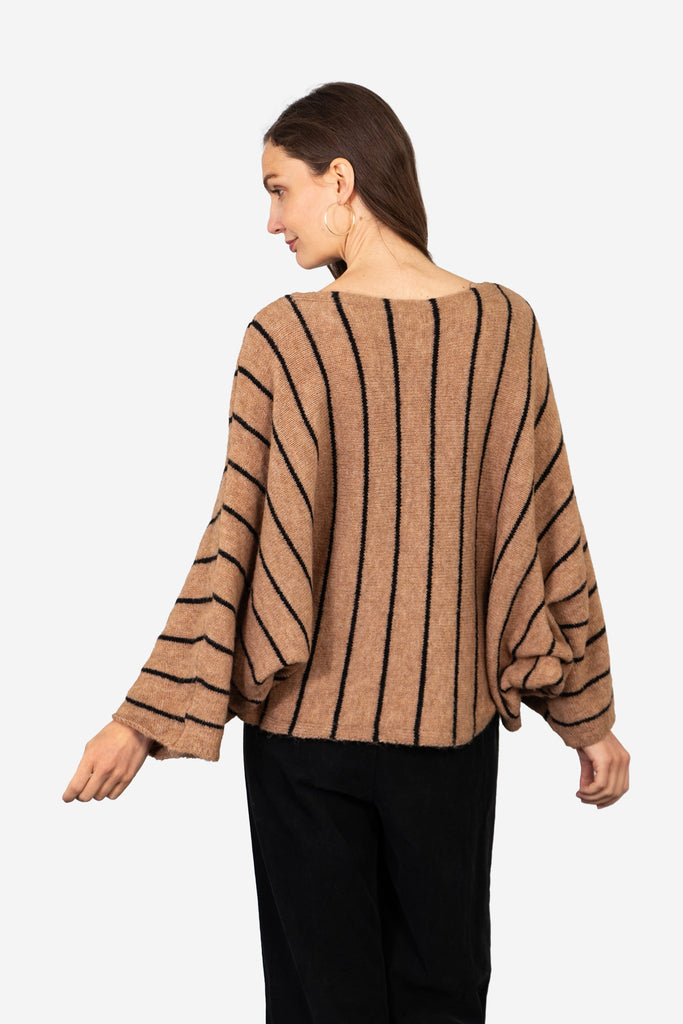 model showing the back of the jumper with an all over striped pattern