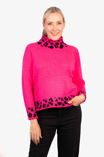 fuchsia pink long sleeve jumper with a high neck, the jumper features a contrasting black leopard print pattern on the neck, trim and cuffs