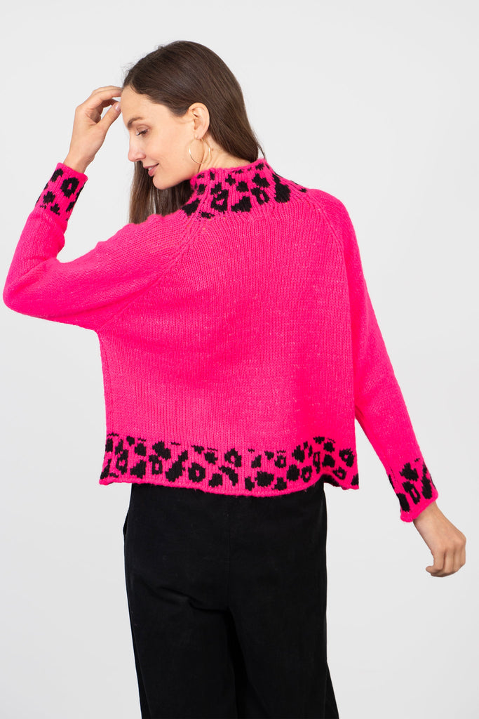 model showing the back of the jumper, the leopard print trim goes right round the design