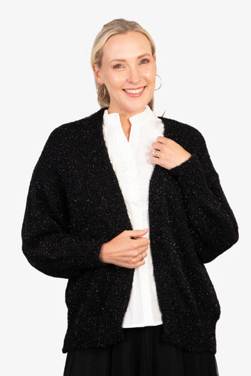 model wearing a gold sparkly tinsel effect knitted cardigan in black