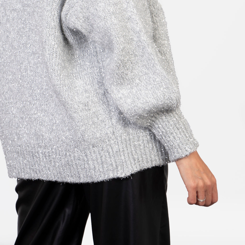 showing the back of the cardigan which falls just below the hip