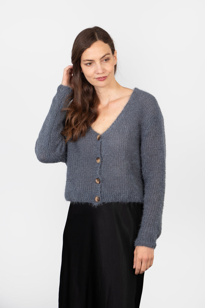 model wearing a heather grey knitted cardigan, with button front and long sleeves