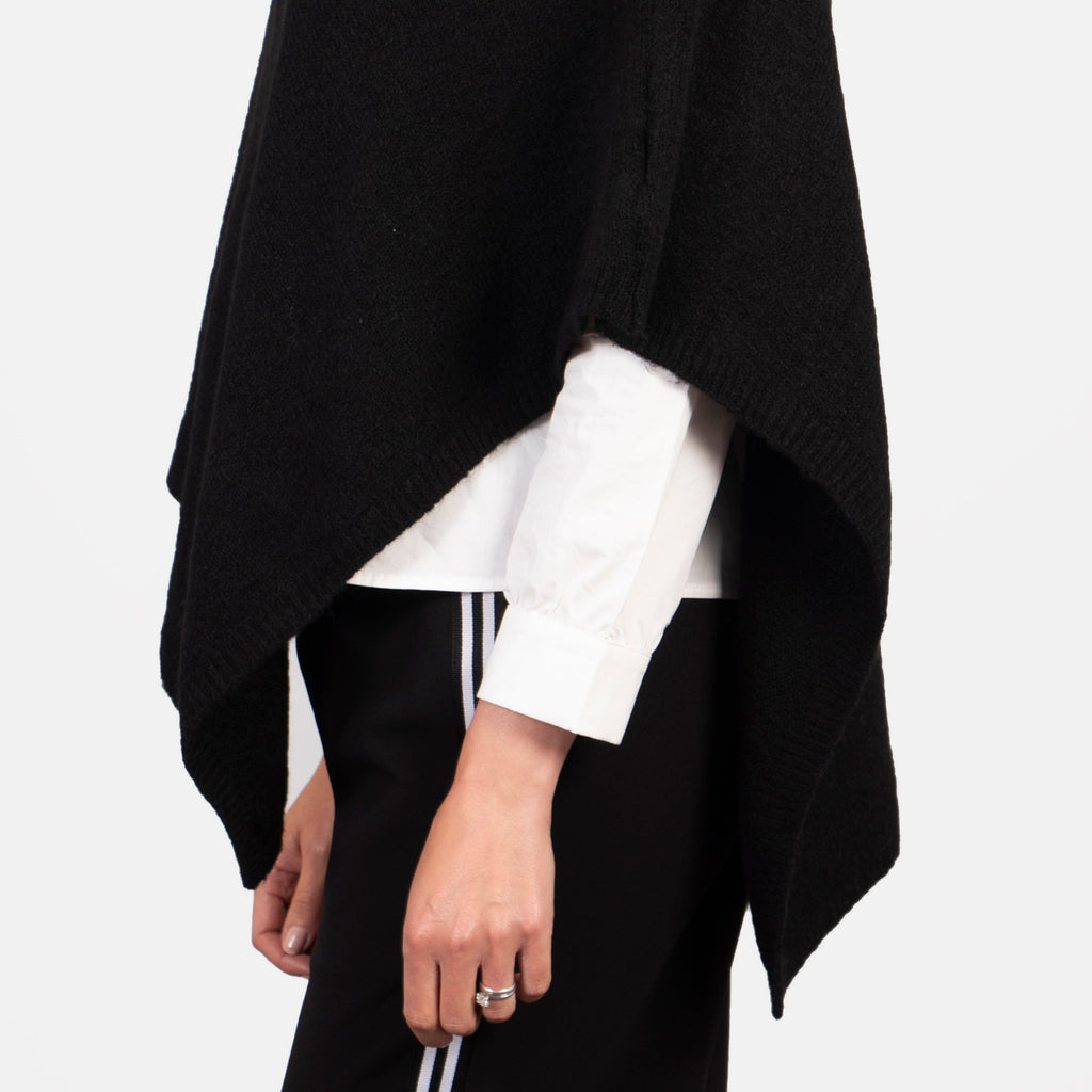 showing the side view of the poncho showing the asymmetric hem line