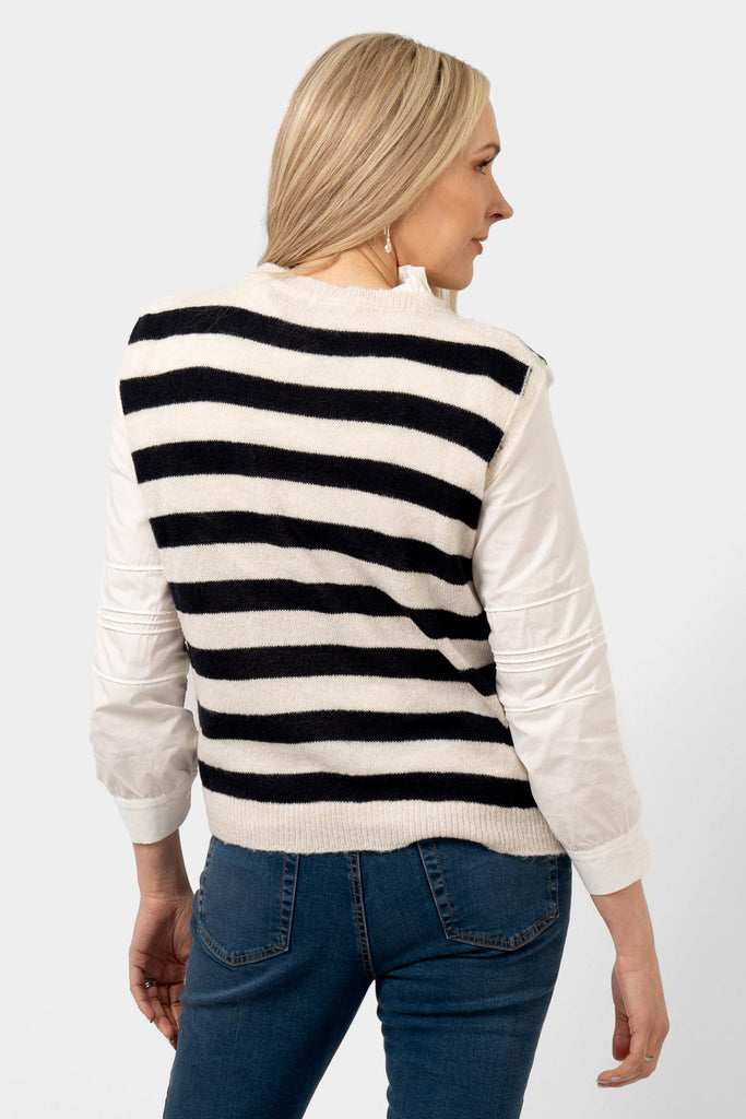 model showing the back of the striped knitted tank top. the navy and cream striped pattern covers the whole of the design.