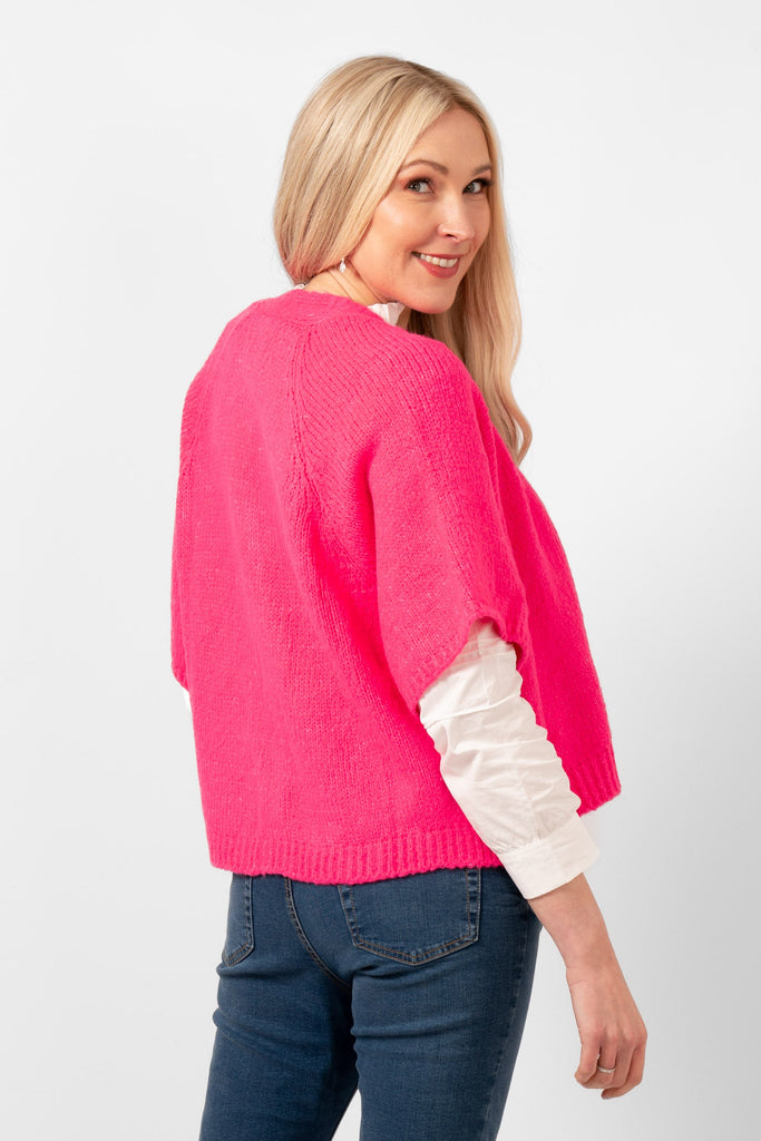 amelia-short-sleeve-wool-blend-cardigan-fuchsia-model-showing-a-side-view-the-cardigan-has-loose-fitting-short-sleeves