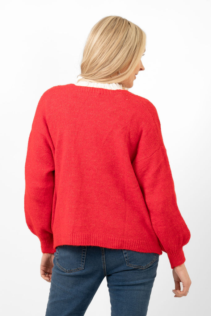 red knitted cardigan shown from the back. the colour of the piece is plain red all over.
