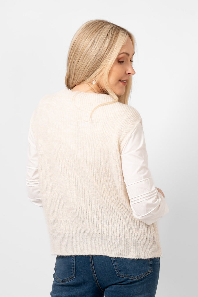 model showing the back of the cream knitted tank top. the colour is plain light cream all over the design.