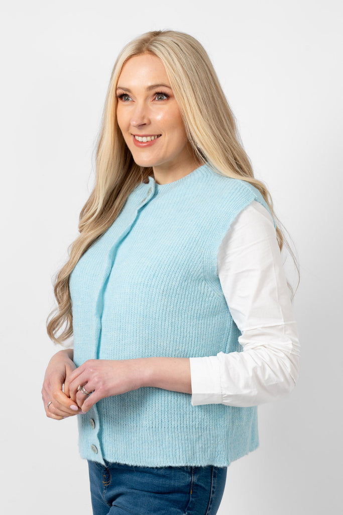 light blue knitted tank top worn by a model. the button front fastenings are visible. 