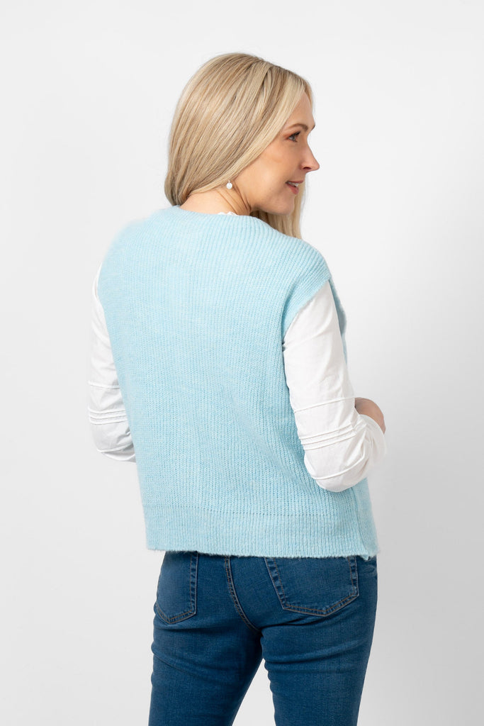 model showing the back of the light blue knitted tank top. the colour is plain light blue all over the design.