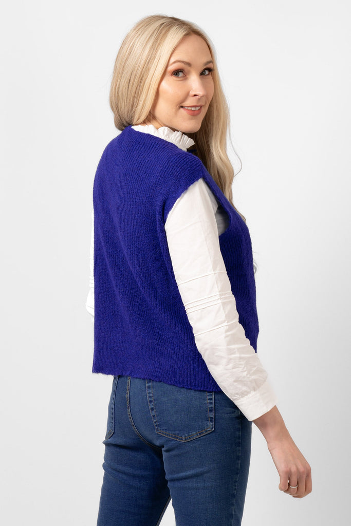model showing the back of the royal blue knitted tank top. the colour is plain  blue all over the design.